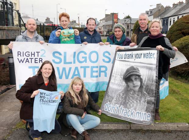 Frack Action members join protesters in Ireland and hold signs against fracking.